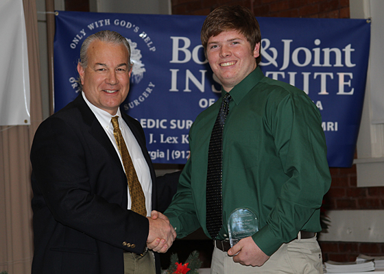 Dr. Kenerly presents academic player of the year award to Spencer Clark